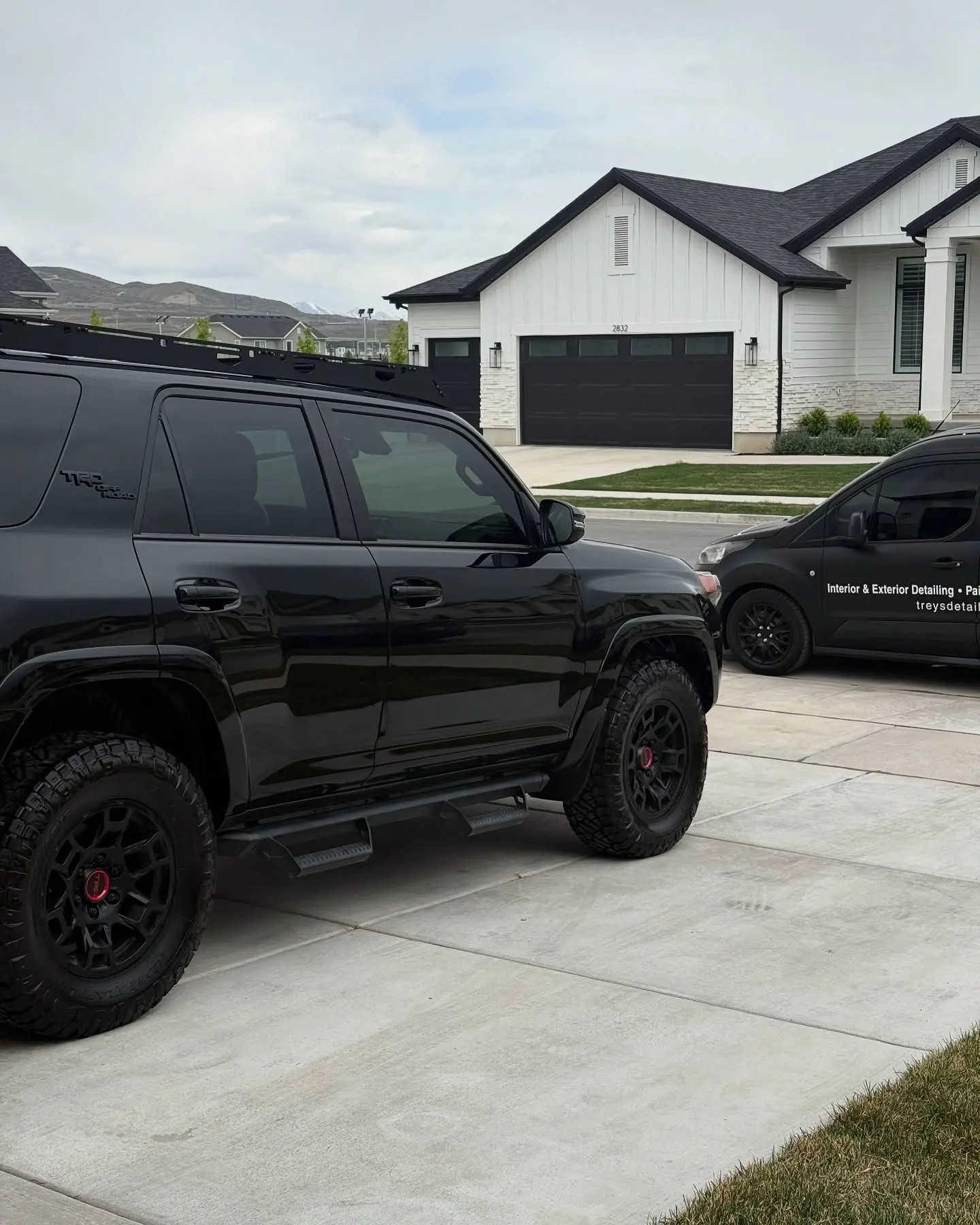 A black Toyota 4Runner detailed in a client driveway