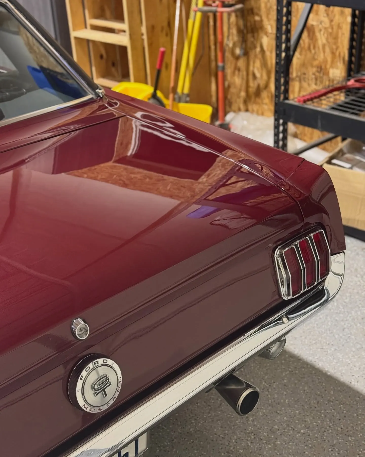 The rear fender and taillight of the 1966 Mustang, deep maroon gloss