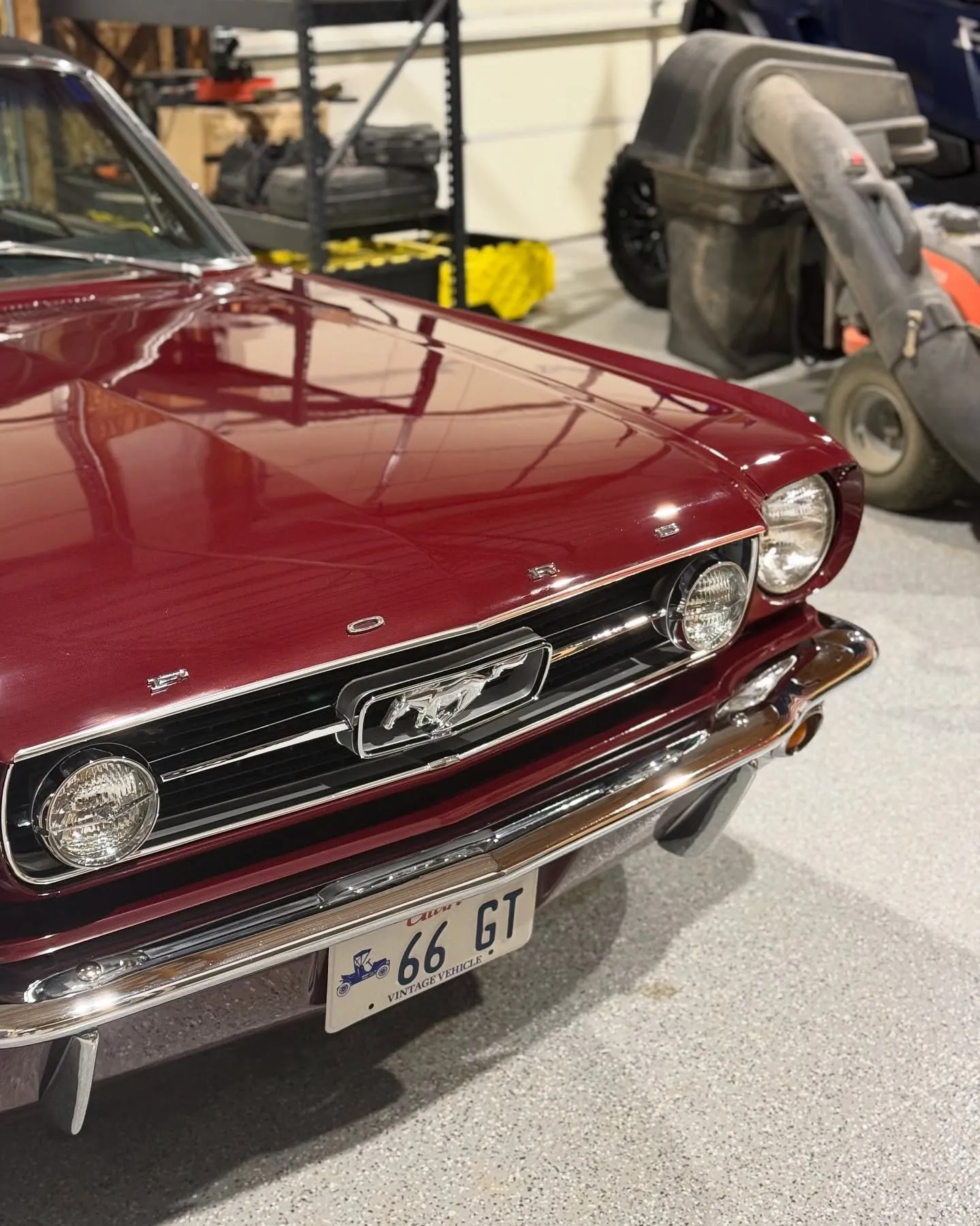 The maroon 1966 Mustang front three-quarter in the shop after correction