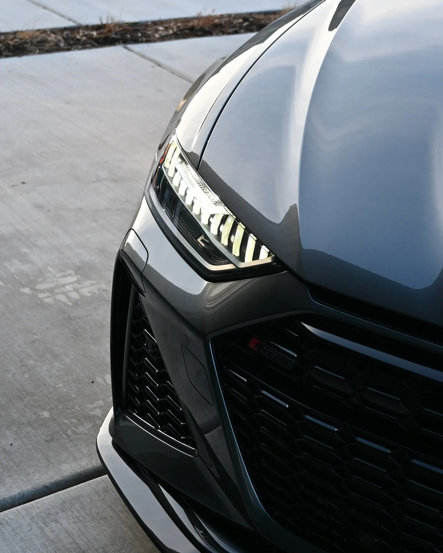 The nose and grille of a gray Audi RS6, up close