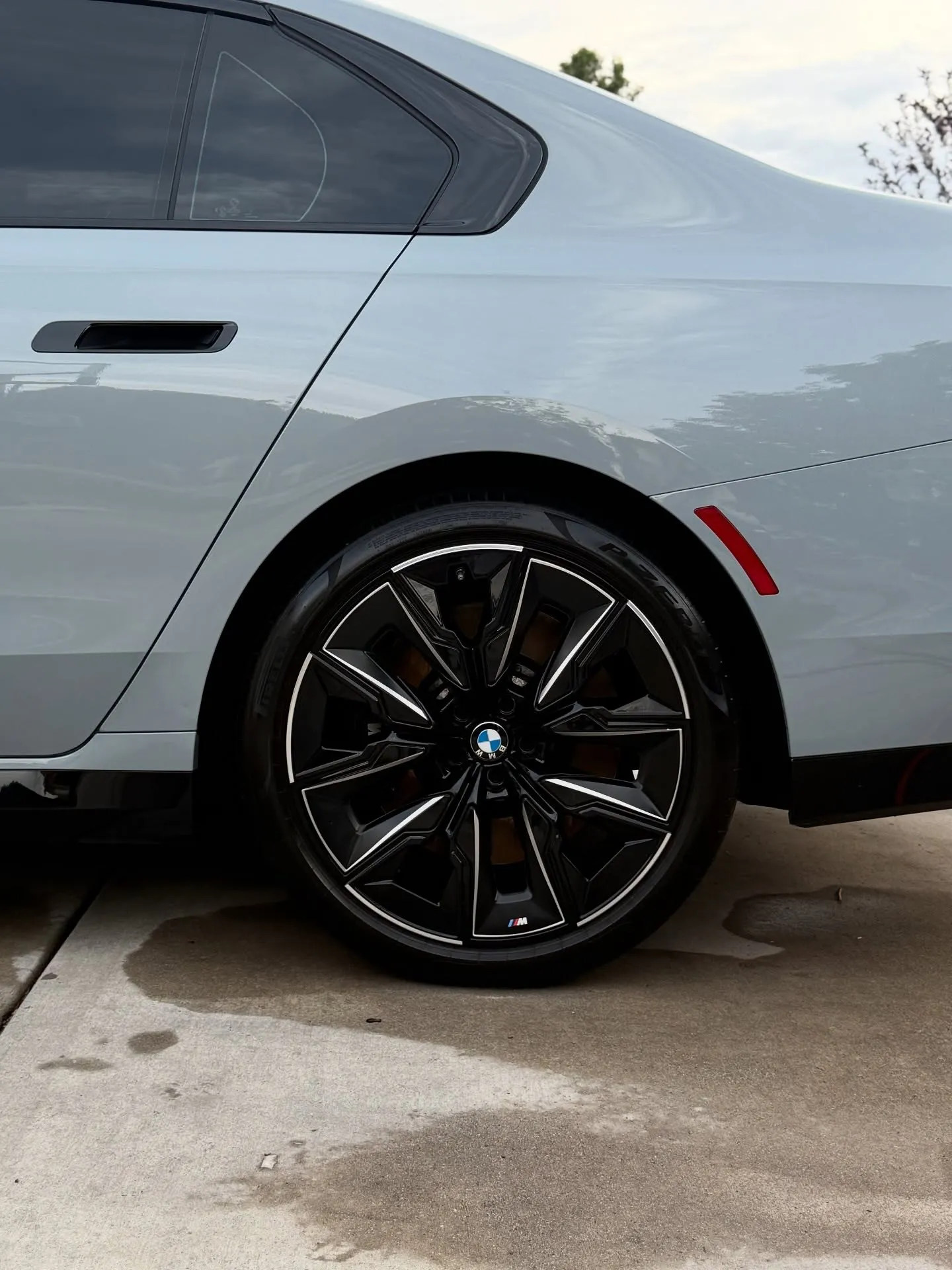 A gray BMW 7 Series with dark rear glass, freshly detailed